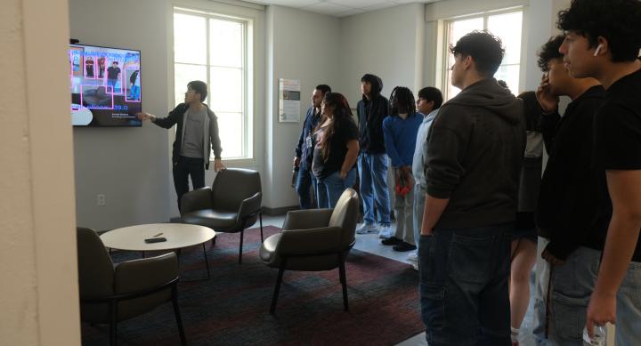 Photo of a GRA presenting during a DVISD student field trip